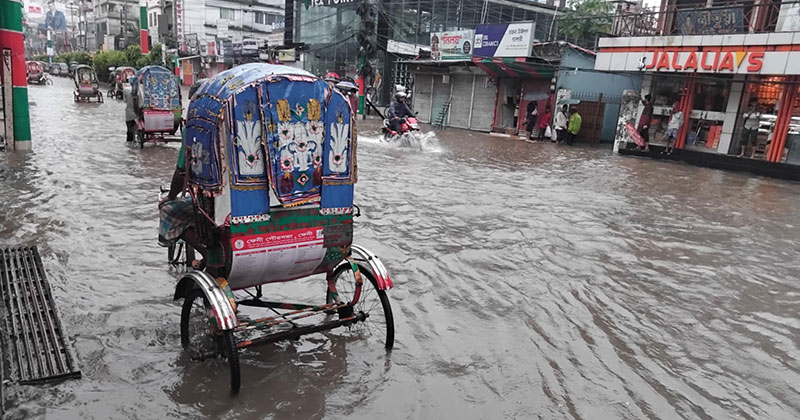 Floodwaters cover a local road in Feni, rendering it impassable and cutting off access to several affected villages. Photo: Voice7 News